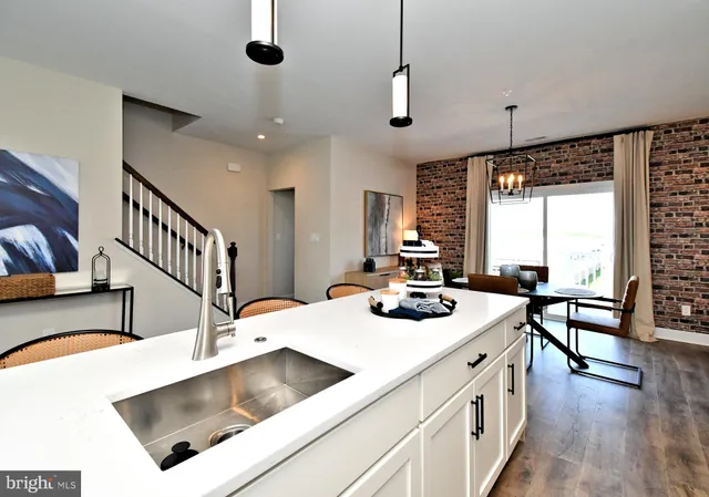 a kitchen with sink cabinets and wooden floor