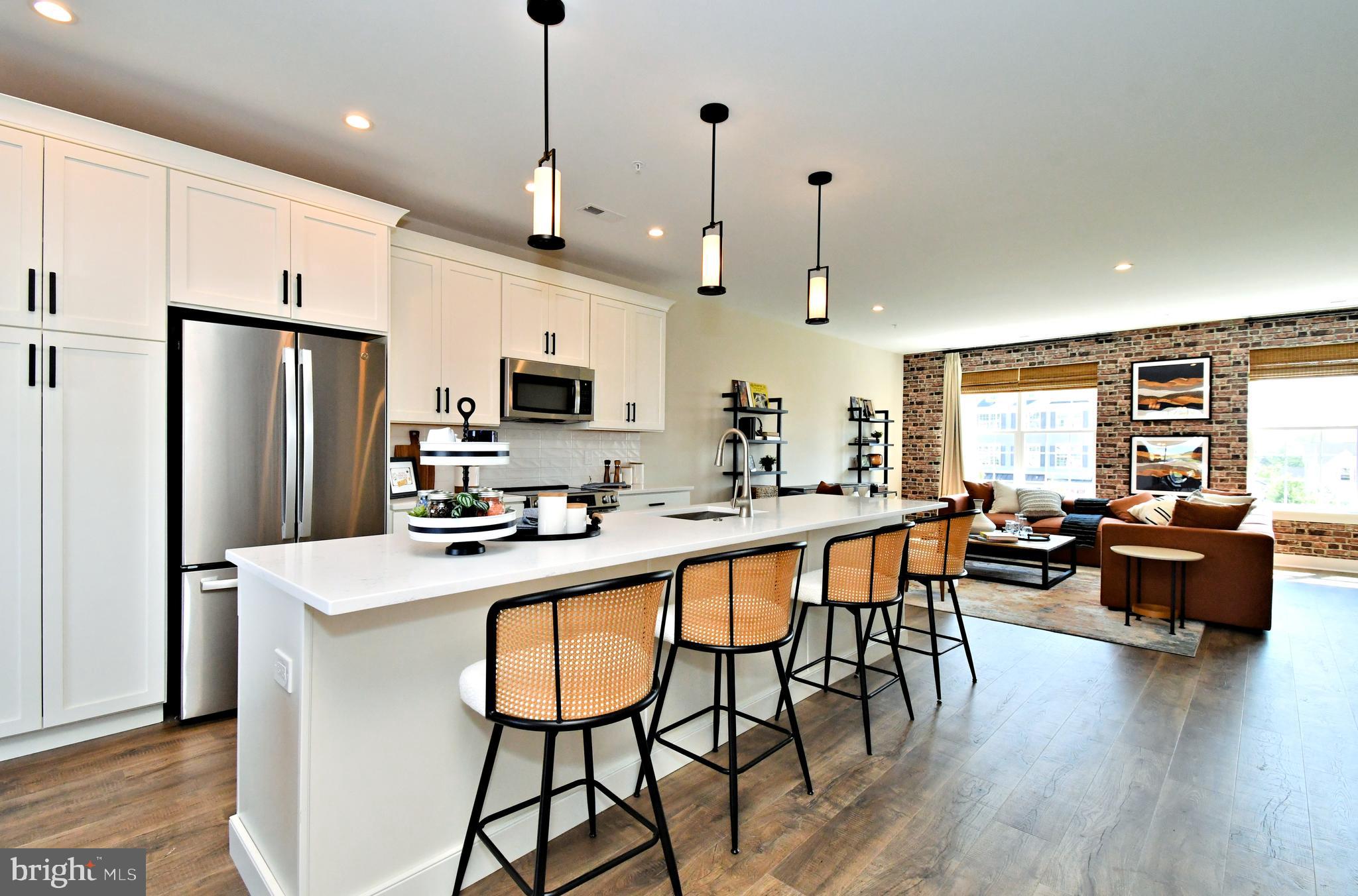 200 Souders Way Souderton, PA 18964 - Photo 19 of 50 a kitchen with stainless steel appliances granite countertop dining table chairs refrigerator and microwave