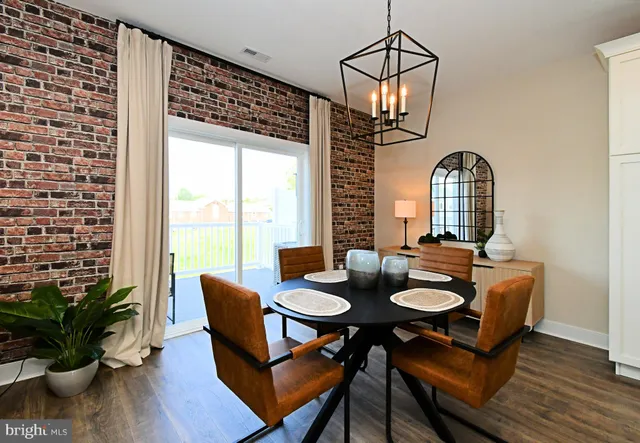 a open dining room with furniture and wooden floor