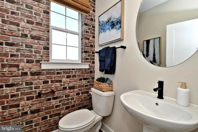 a view of a hallway with wooden floor and entryway