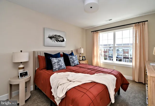 a bedroom with a bed and a large window