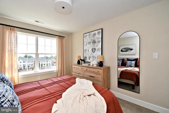 a bedroom with a bed and a lamp