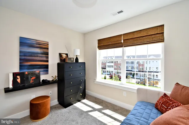 a living room with furniture and a lamp