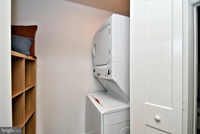 a kitchen with stainless steel appliances kitchen island granite countertop a dining table chairs refrigerator and sink