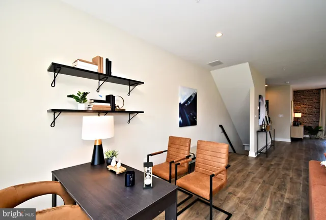 a view of a room with furniture and wooden floor