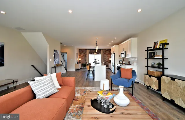 a living room with furniture kitchen view and a table