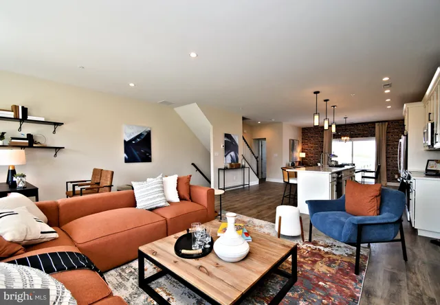 a living room with furniture and a dining table with wooden floor