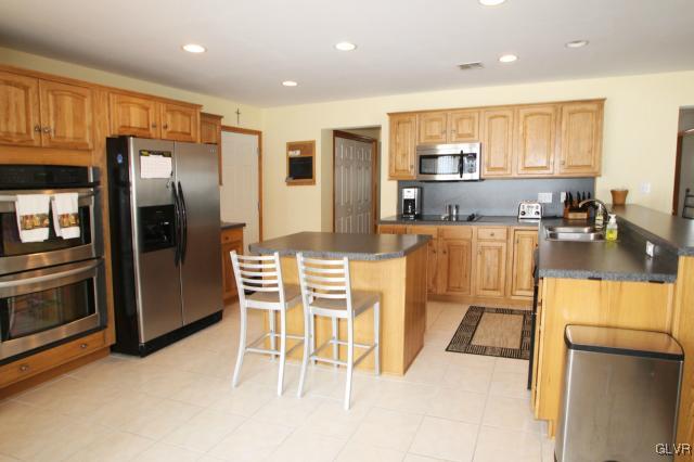 2768 Maefield Road Bath, PA 18014 - Photo 10 of 20 a kitchen with stainless steel appliances granite countertop a refrigerator and a stove top oven