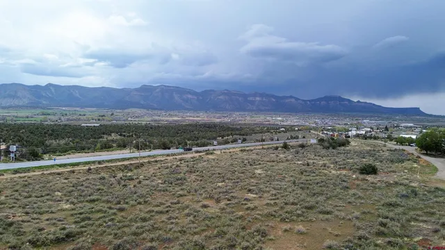 a view of a dry yard with wooden fence
