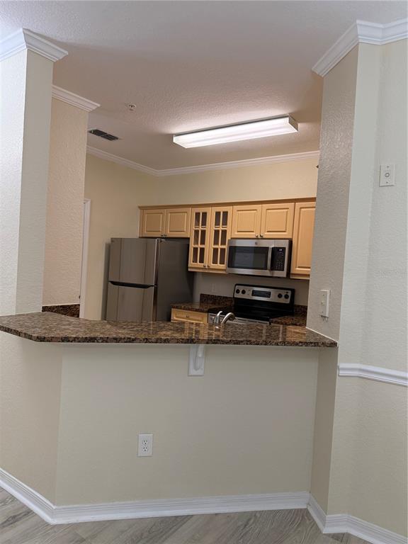 3725 Conroy Road, Unit 2127 Orlando, FL 32839 - Photo 9 of 30 a living room with stainless steel appliances granite countertop a sink a stove and a refrigerator