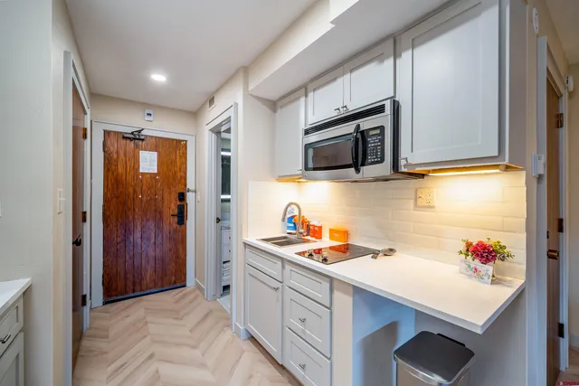 a bedroom with a large bed and a chandelier