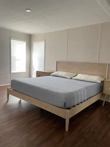 a bedroom with a bed and window