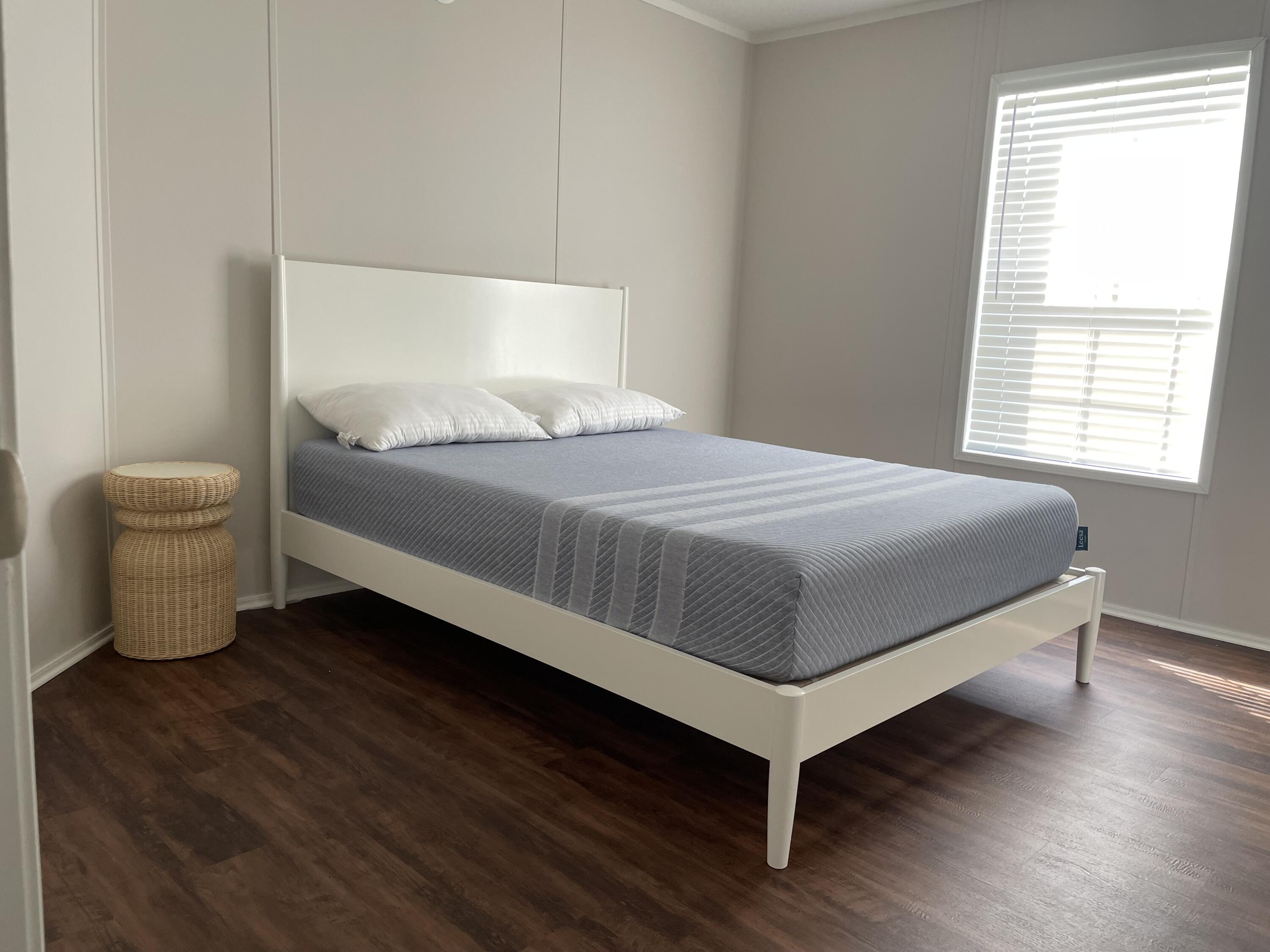 18459 260th Street Okeechobee, FL 34972 - Photo 13 of 15 a bedroom with a bed and wooden floor