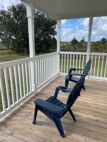 a view of a chairs on wooden deck