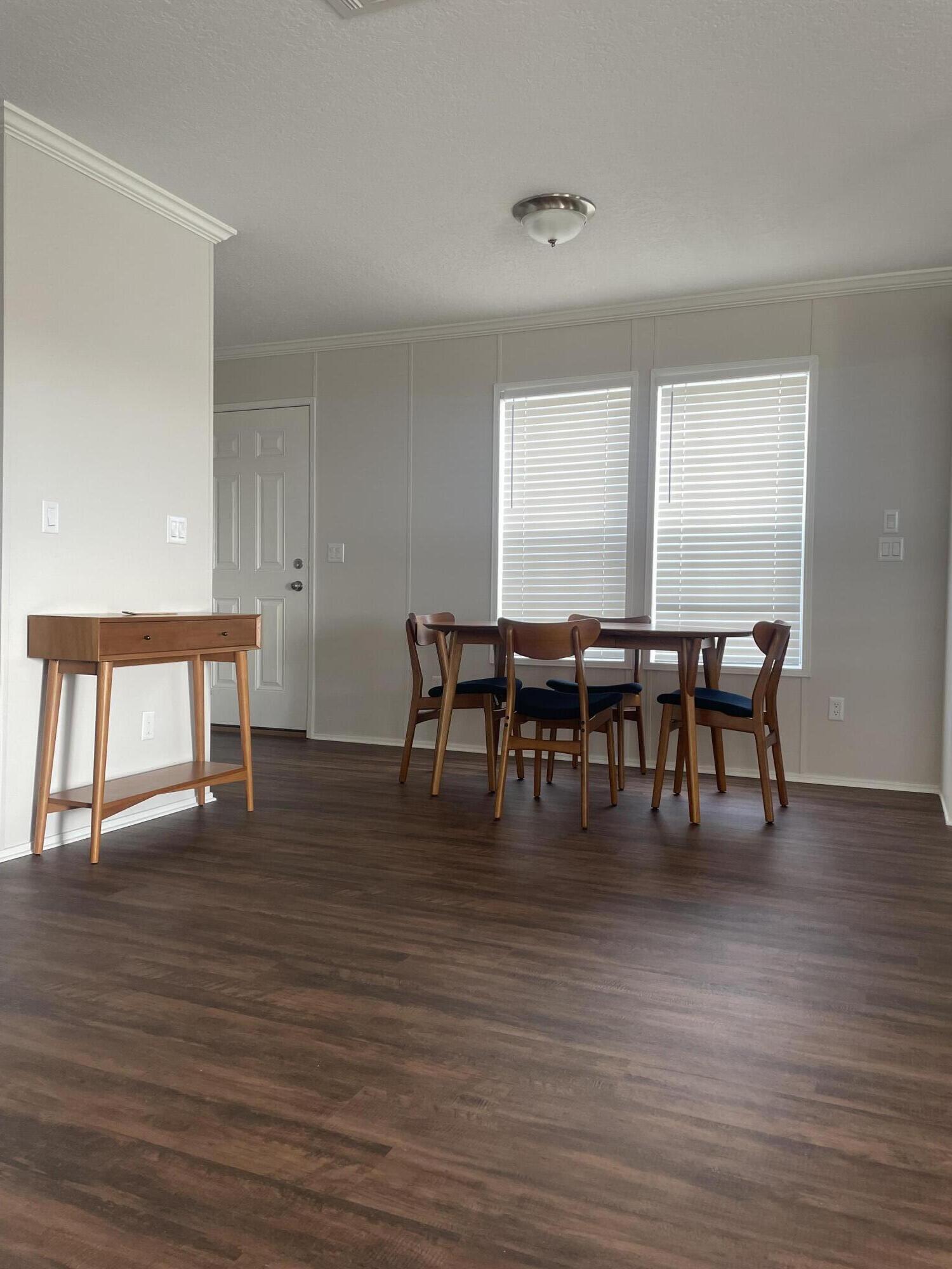 18459 260th Street Okeechobee, FL 34972 - Photo 10 of 15 a view of a dining room with furniture and wooden floor