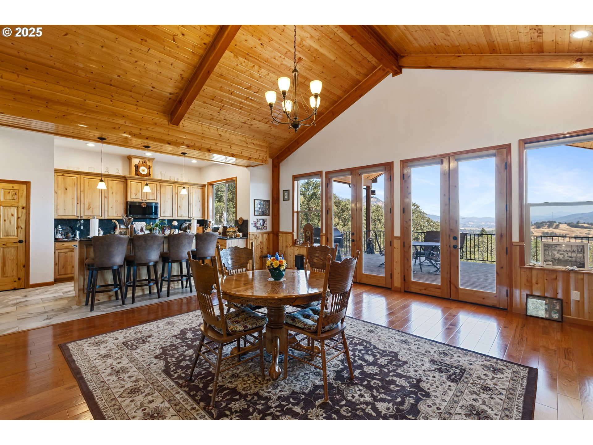 1757 Riddle Bypass Road Riddle, OR 97469 - Photo 11 of 38 a dining room with furniture a rug and a large window