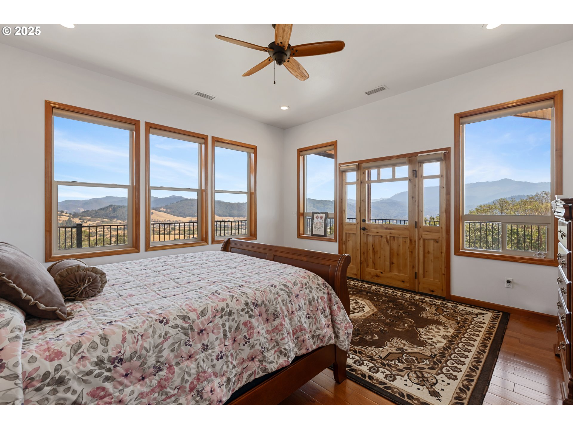 1757 Riddle Bypass Road Riddle, OR 97469 - Photo 12 of 38 a bedroom with a large bed and a large window