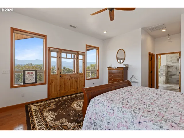 a bedroom with a bed and a large window
