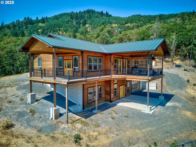 a view of a house with a yard and sitting area