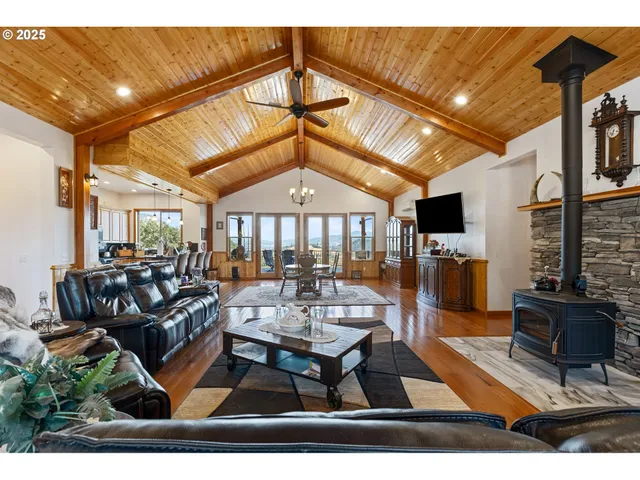 a living room with furniture a wooden floor and a fireplace