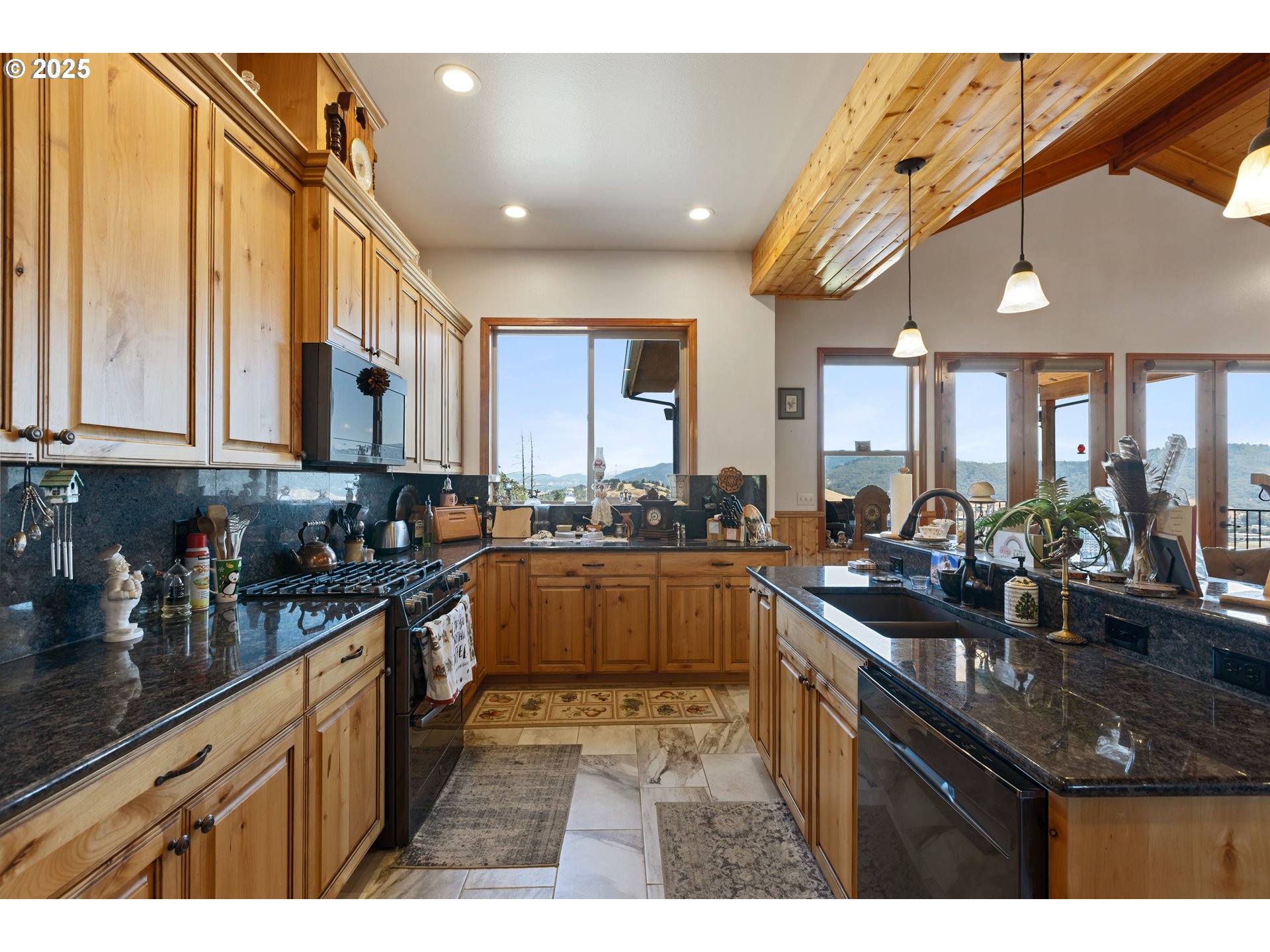 1757 Riddle Bypass Road Riddle, OR 97469 - Photo 10 of 38 a kitchen with stainless steel appliances granite countertop a sink stove and cabinets