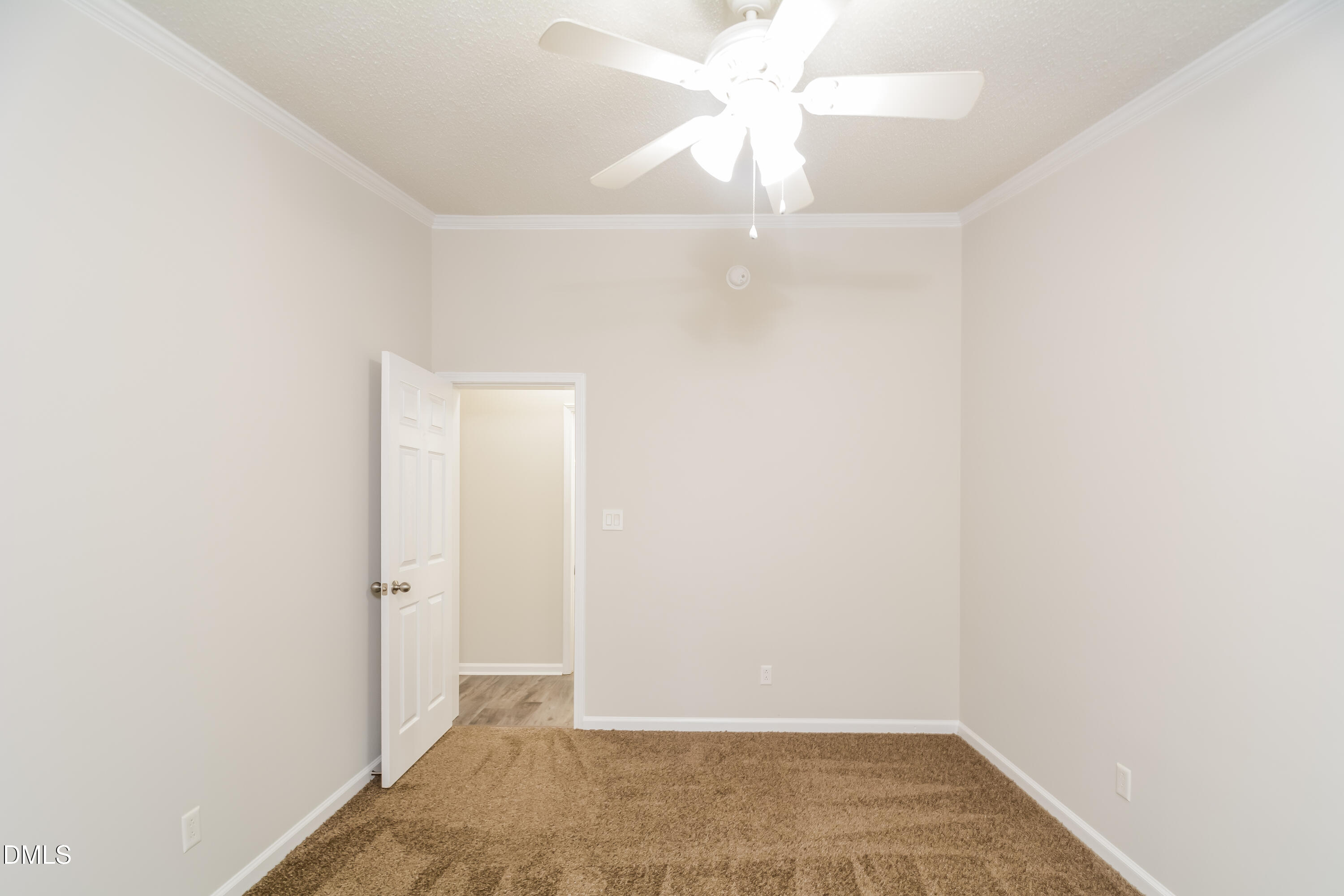 617 East Walnut Avenue Wake Forest, NC 27587 - Photo 12 of 16 an empty room with a ceiling fan and a window