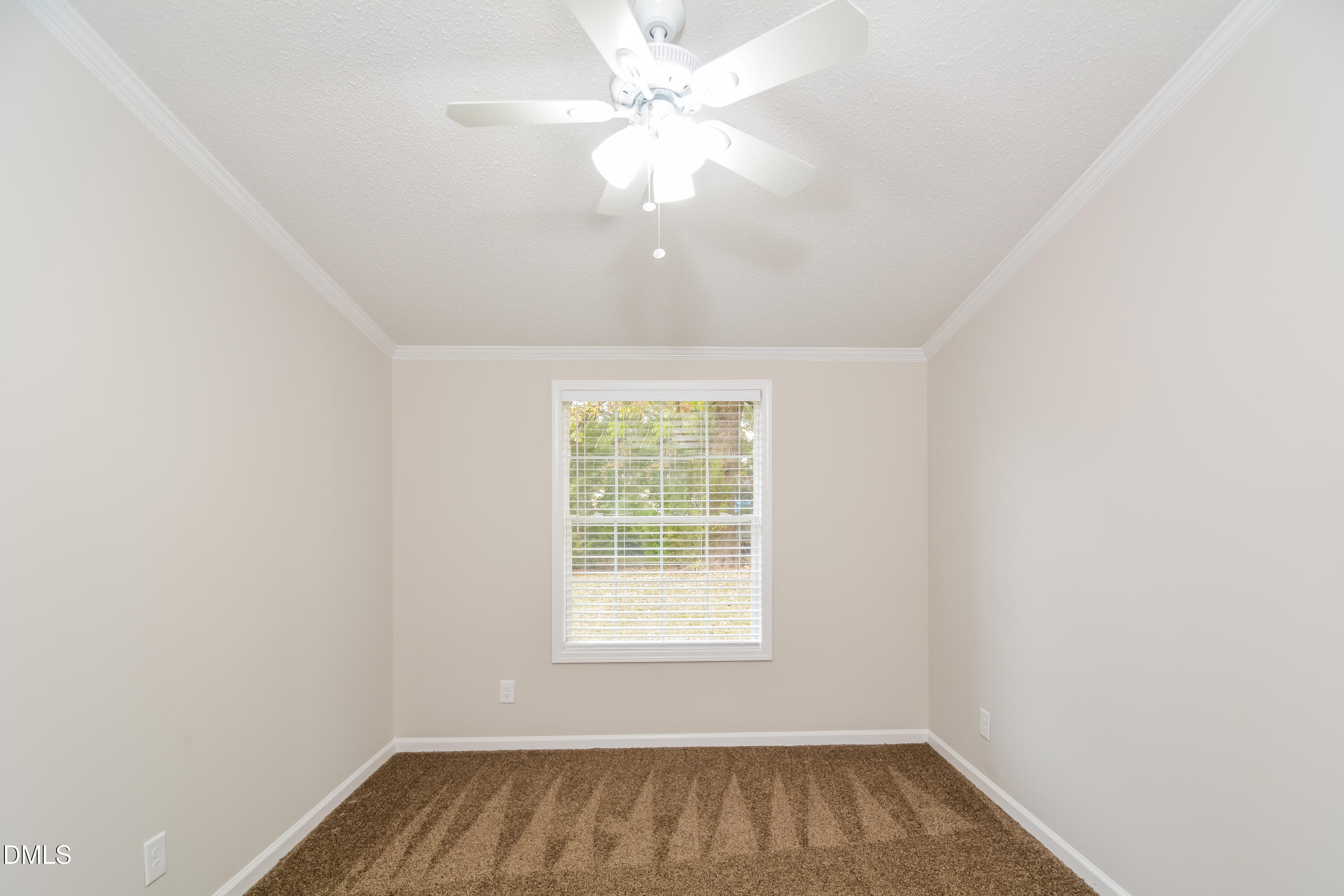 617 East Walnut Avenue Wake Forest, NC 27587 - Photo 13 of 16 an empty room with a window and a fan