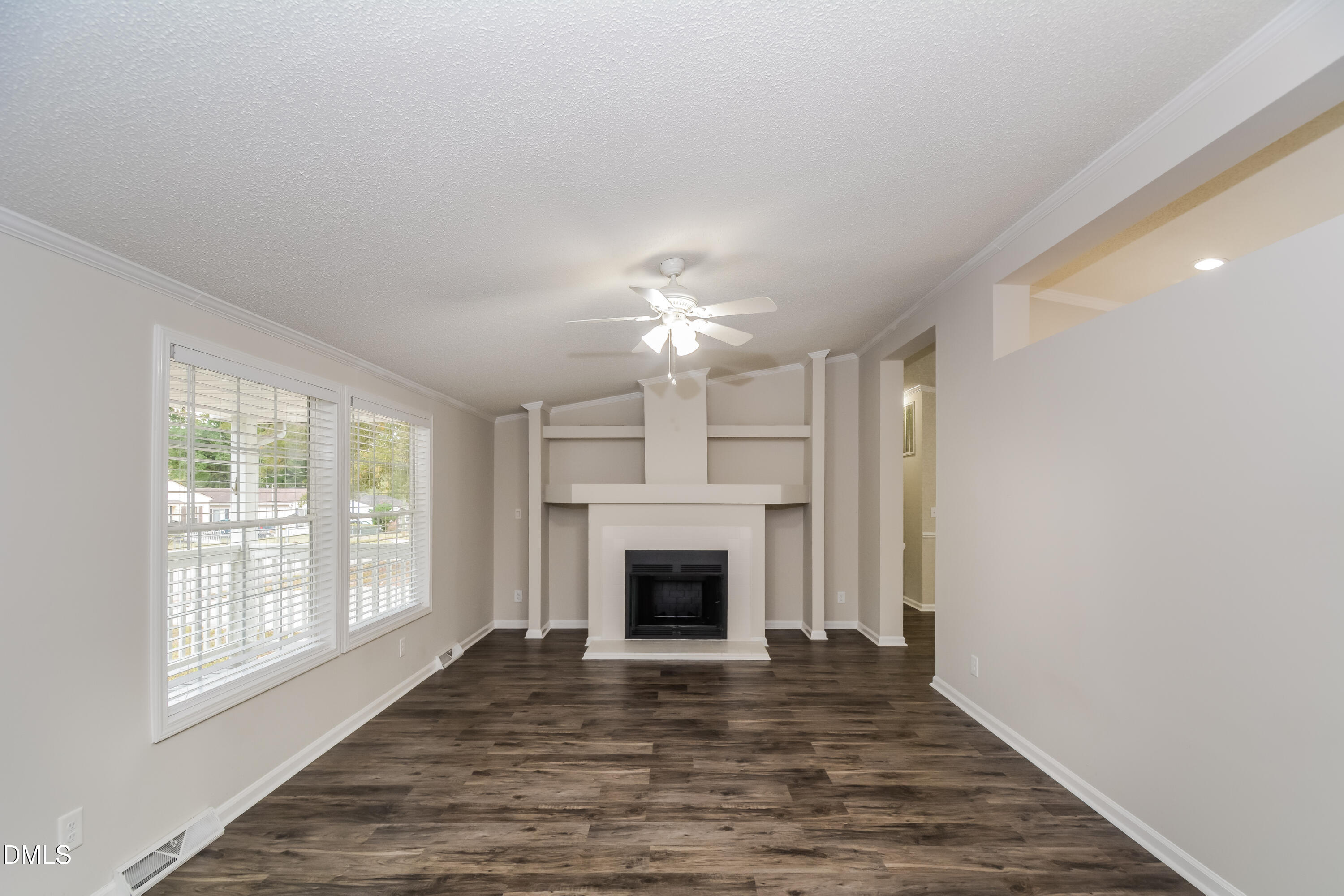 617 East Walnut Avenue Wake Forest, NC 27587 - Photo 2 of 16 a view of an empty room with a fireplace and a window