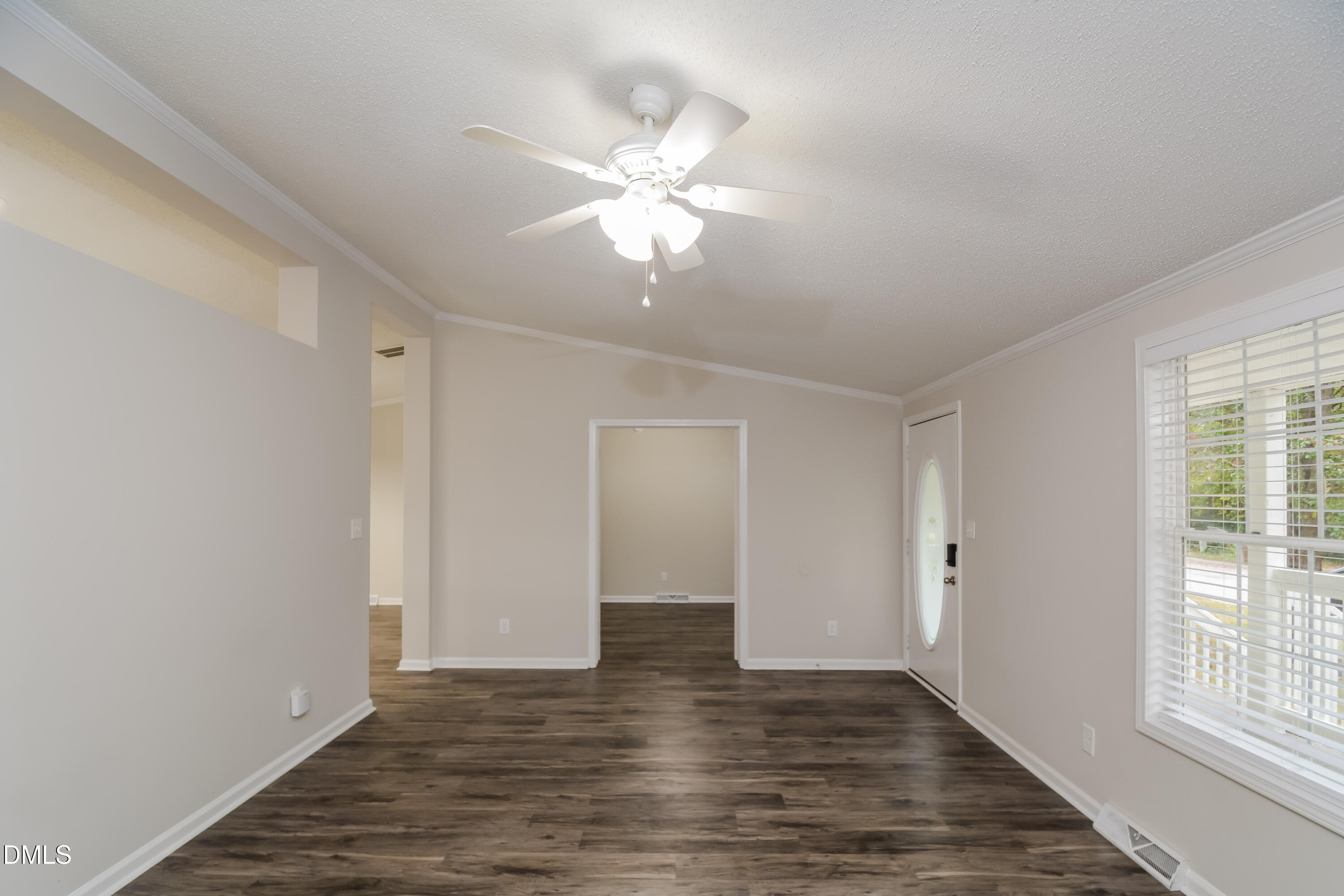 617 East Walnut Avenue Wake Forest, NC 27587 - Photo 3 of 16 a view of an empty room with wooden floor and a window