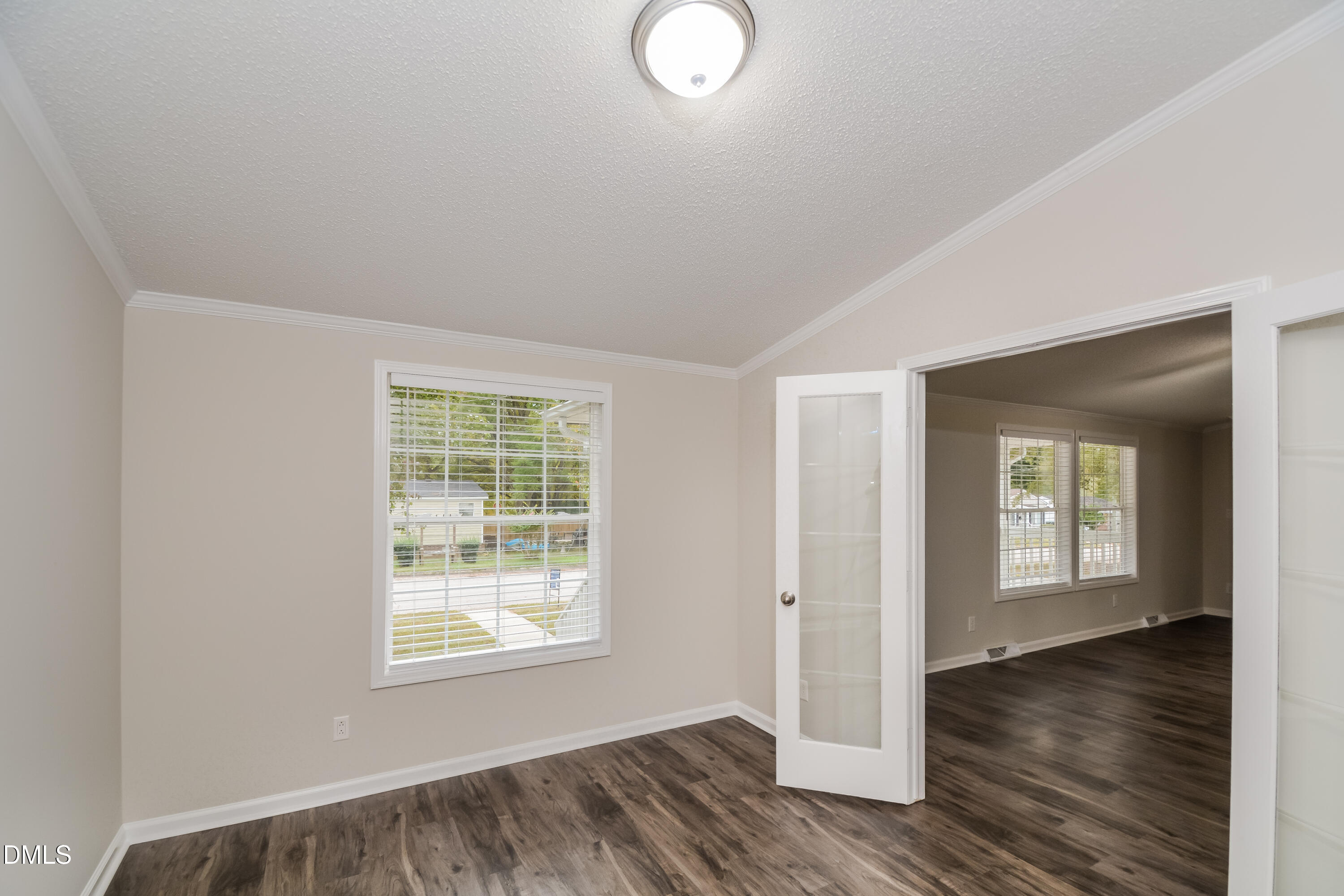 617 East Walnut Avenue Wake Forest, NC 27587 - Photo 5 of 16 a view of an empty room with wooden floor and a window