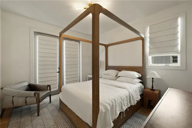 a bed sitting in a bedroom next to a window