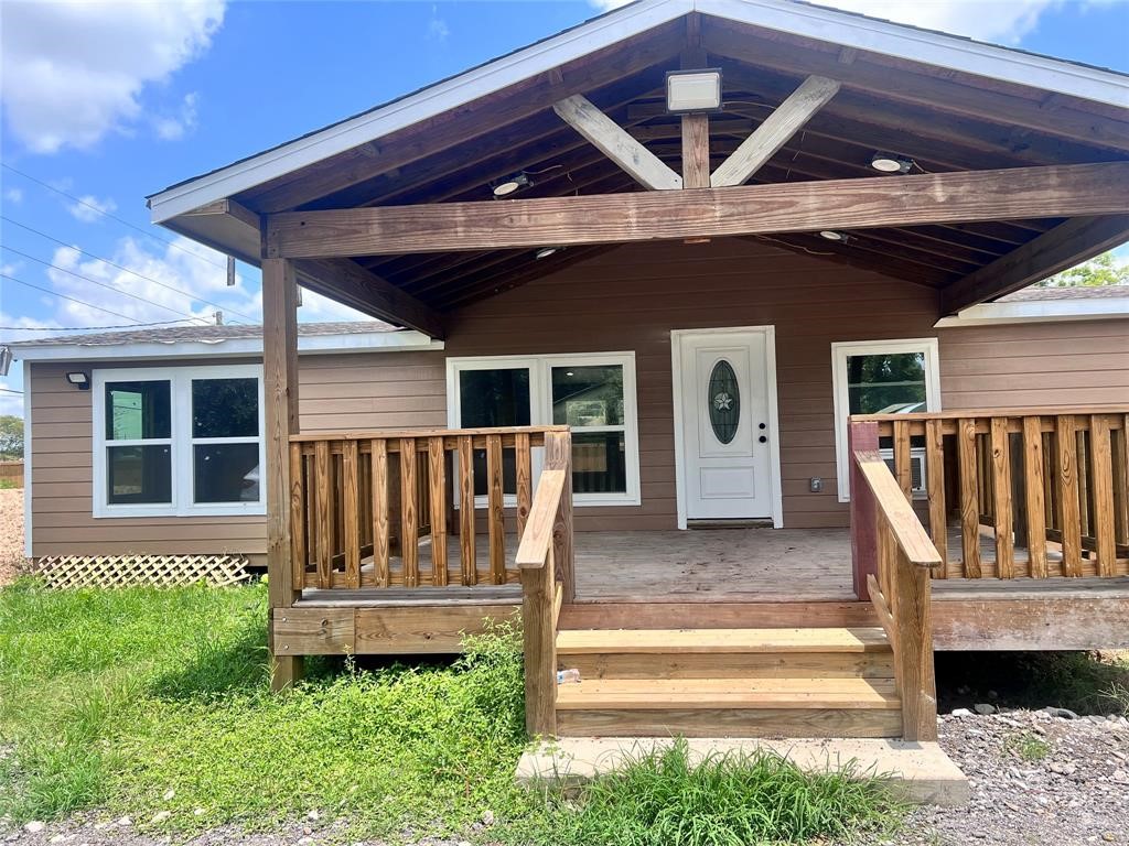 a view of a chair and table in the patio with wooden fence
