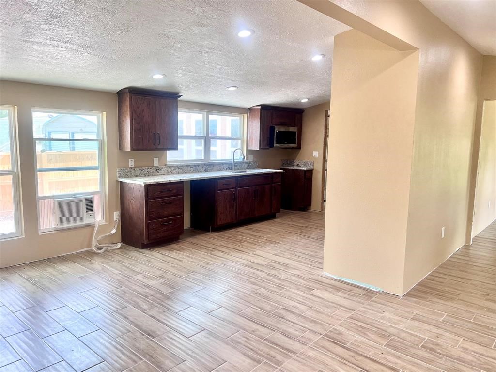 9115 Puritan Way Rosharon, TX 77583 - Photo 4 of 9 a large kitchen with stainless steel appliances granite countertop a refrigerator and a sink