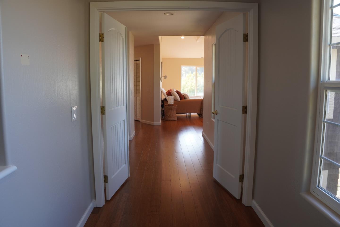 389 Corralitos Road Watsonville, CA 95076 - Photo 13 of 18 a view of a hallway and wooden floor and a livingroom with furniture