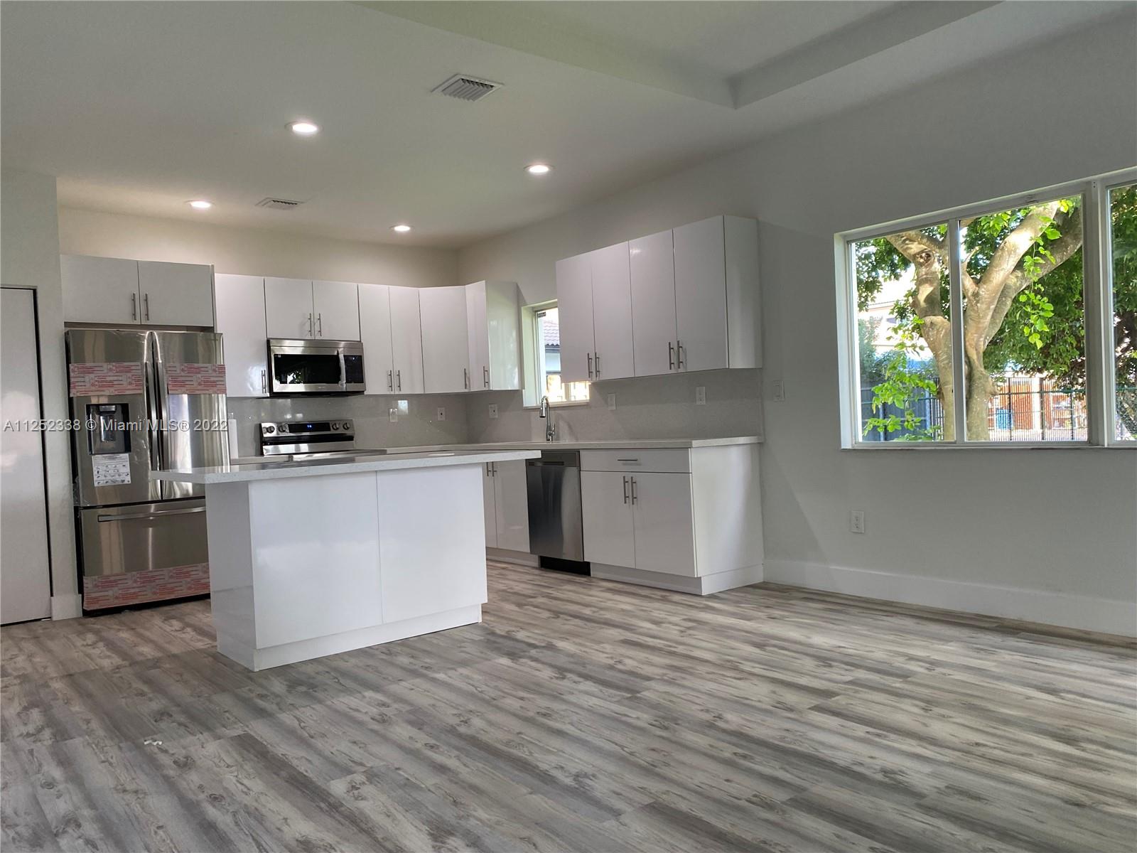 16350 Southwest 50th Terrace Miami, FL 33185 - Photo 11 of 59 a kitchen with stainless steel appliances granite countertop a stove a sink and a refrigerator