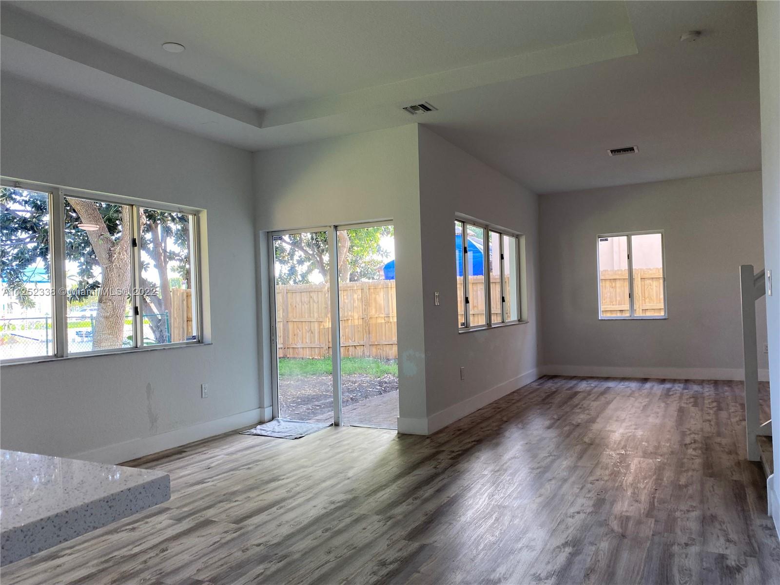 16350 Southwest 50th Terrace Miami, FL 33185 - Photo 12 of 59 a view of an empty room with wooden floor and a window