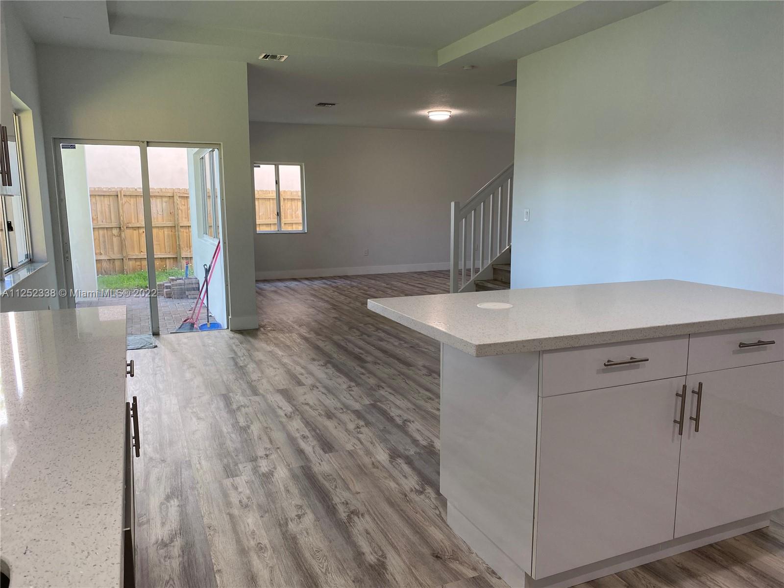 16350 Southwest 50th Terrace Miami, FL 33185 - Photo 13 of 59 an entryway with wooden floor and cabinet