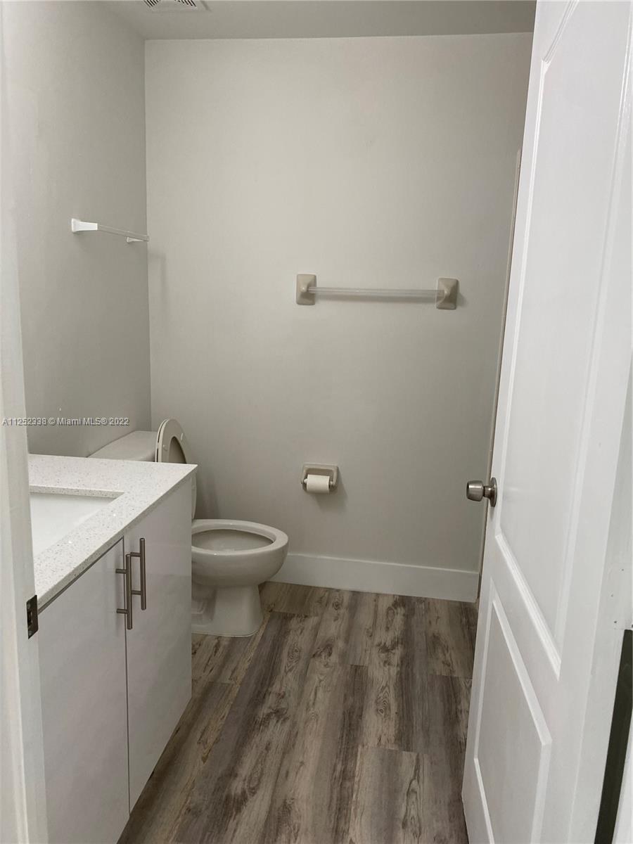 16350 Southwest 50th Terrace Miami, FL 33185 - Photo 18 of 59 a bathroom with a granite countertop sink toilet and a mirror