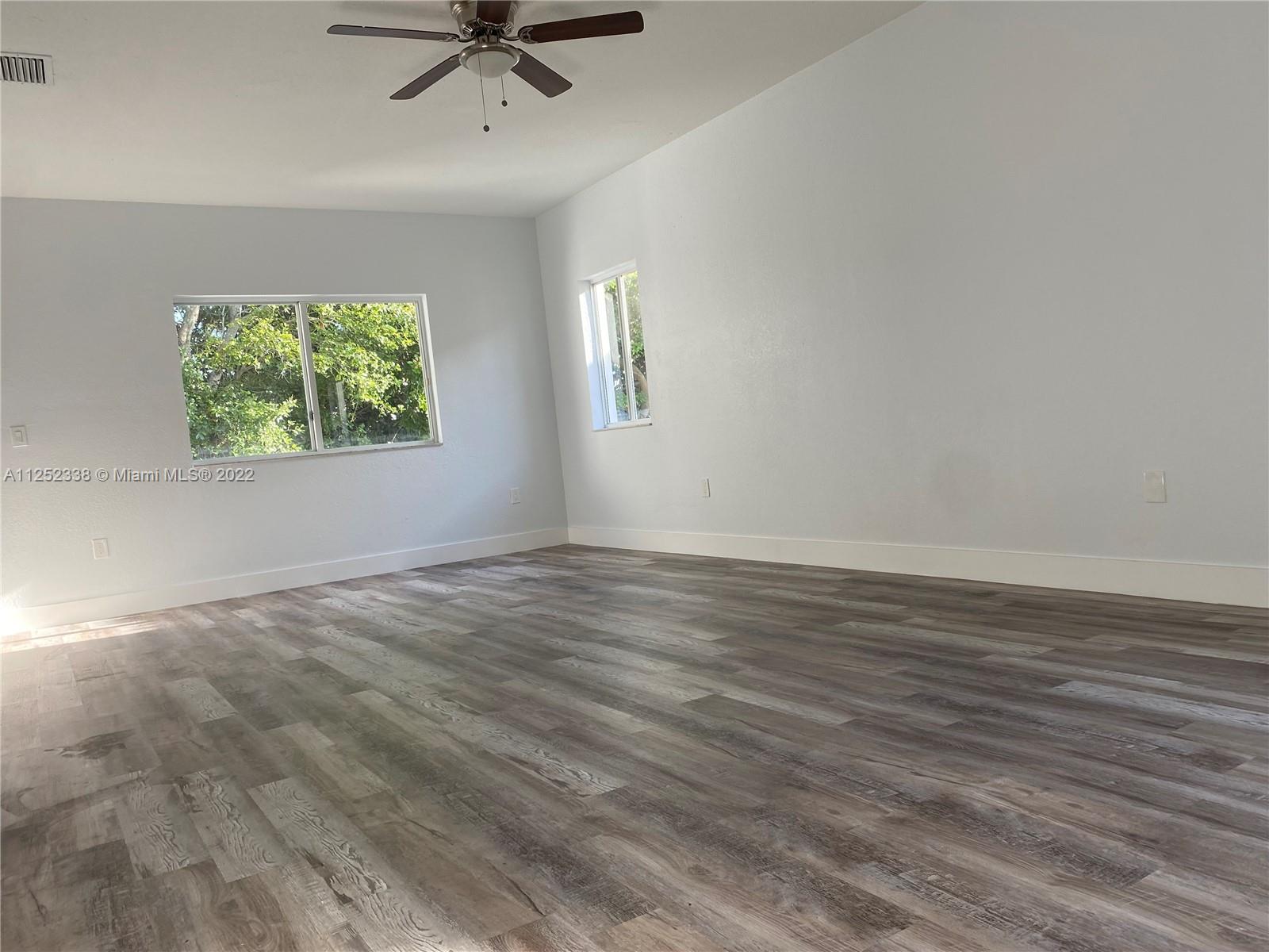 16350 Southwest 50th Terrace Miami, FL 33185 - Photo 21 of 59 wooden floor in an empty room with a window
