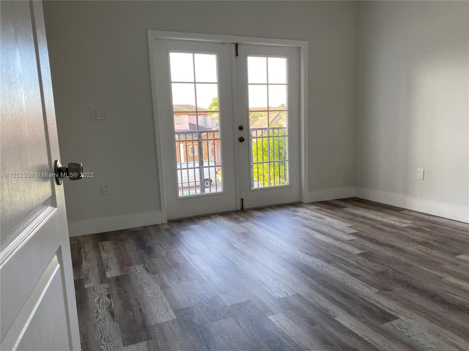 16350 Southwest 50th Terrace Miami, FL 33185 - Photo 31 of 59 an empty room with wooden floor and windows