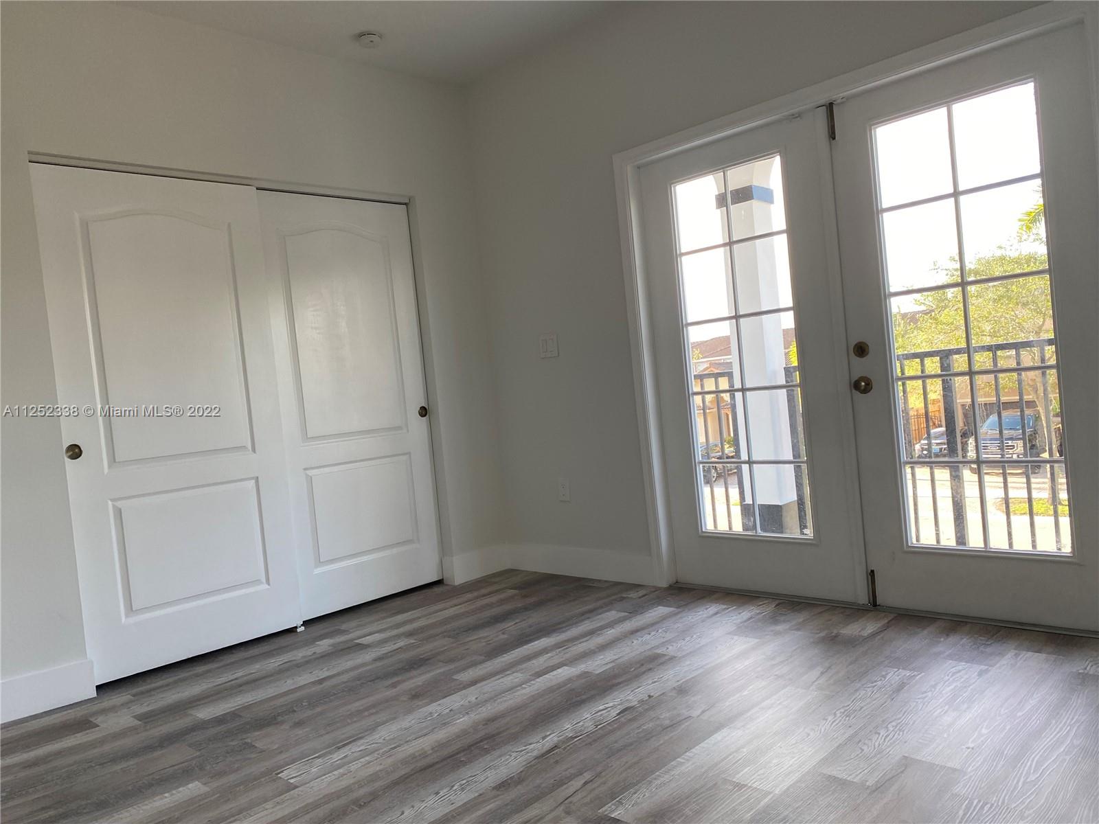 16350 Southwest 50th Terrace Miami, FL 33185 - Photo 37 of 59 a view of an empty room with wooden floor and a window