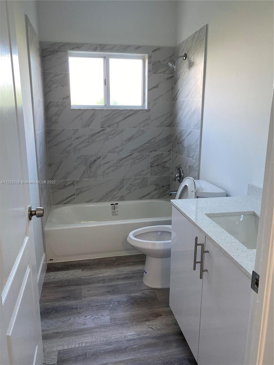 16350 Southwest 50th Terrace Miami, FL 33185 - Photo 38 of 59 a bathroom with a sink toilet and shower