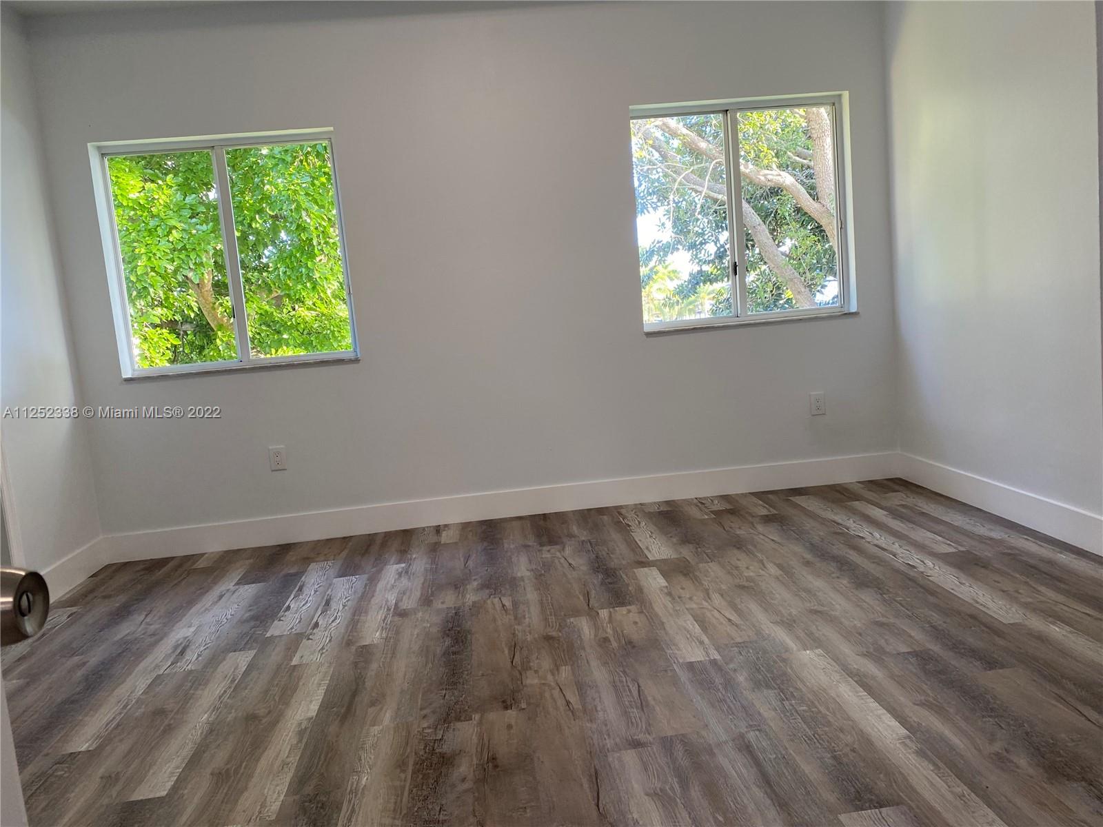 16350 Southwest 50th Terrace Miami, FL 33185 - Photo 41 of 59 a view of an empty room with wooden floor and a window
