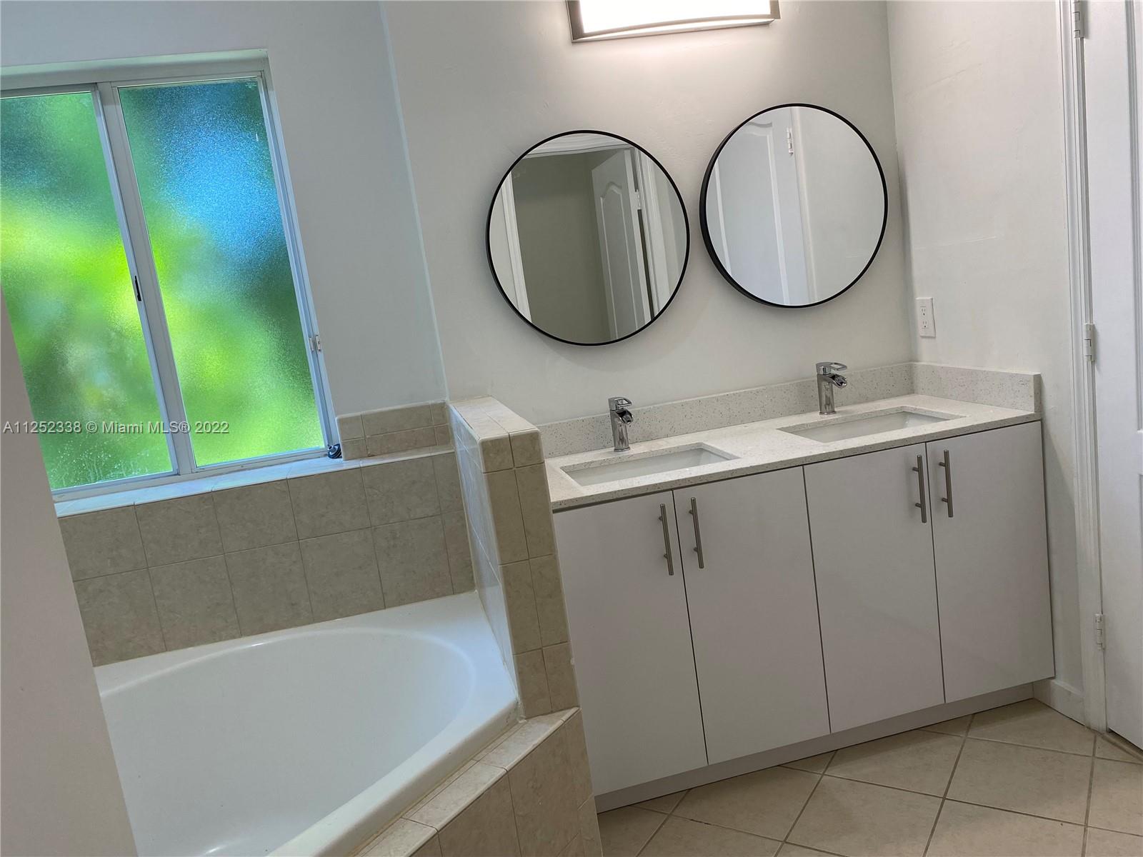 16350 Southwest 50th Terrace Miami, FL 33185 - Photo 50 of 59 a bathroom with a sink and a mirror