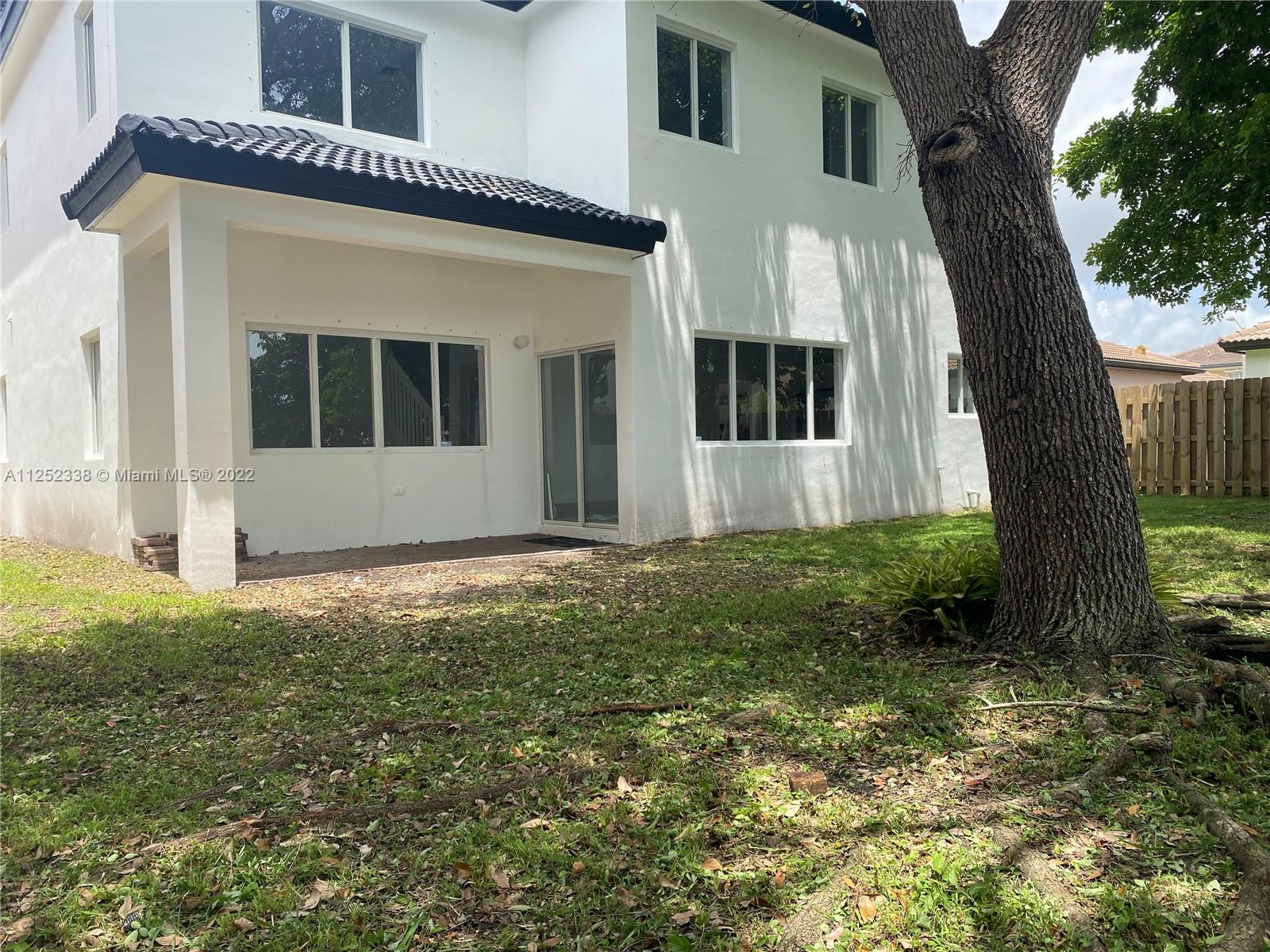 16350 Southwest 50th Terrace Miami, FL 33185 - Photo 54 of 59 a front view of a house with garden