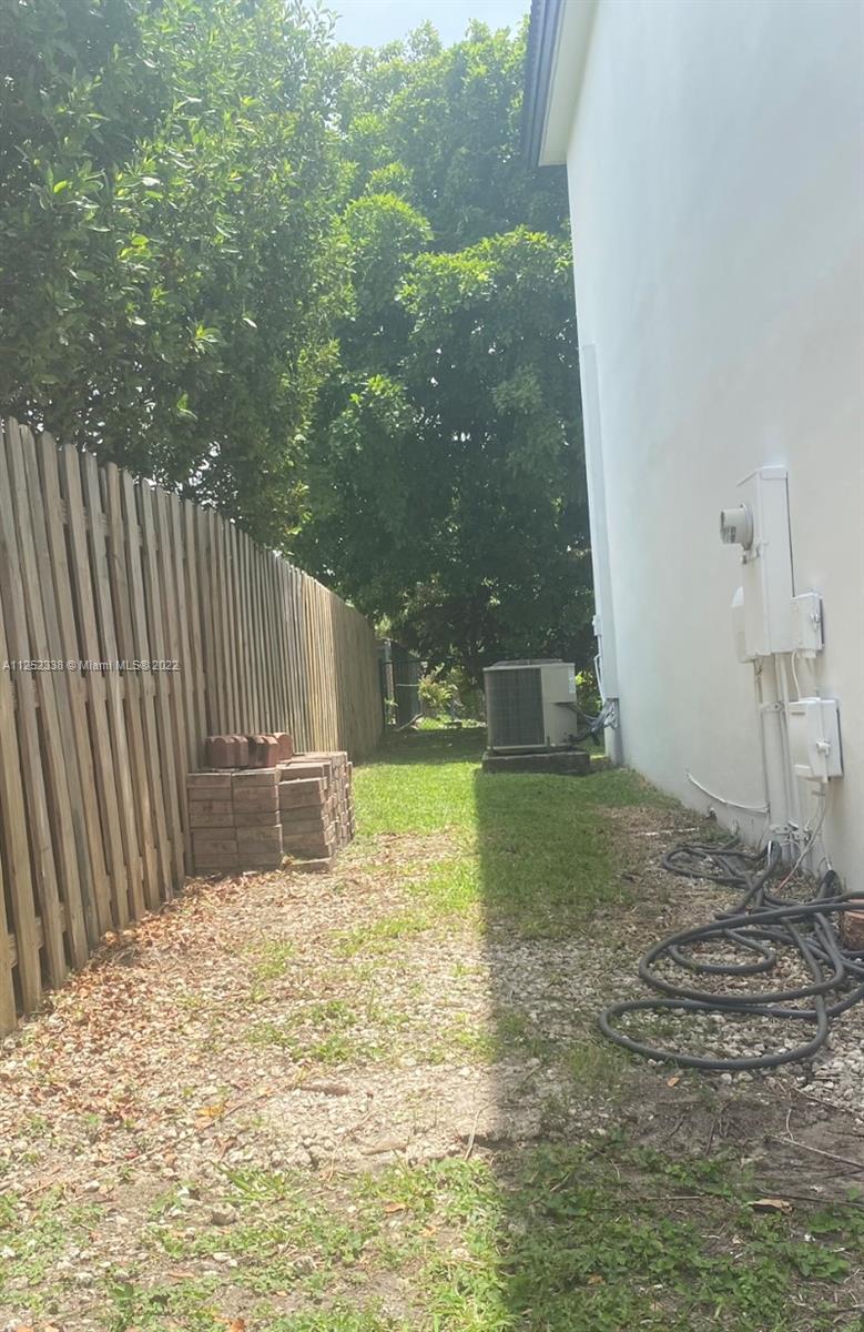 16350 Southwest 50th Terrace Miami, FL 33185 - Photo 59 of 59 a backyard of a house with table and chairs