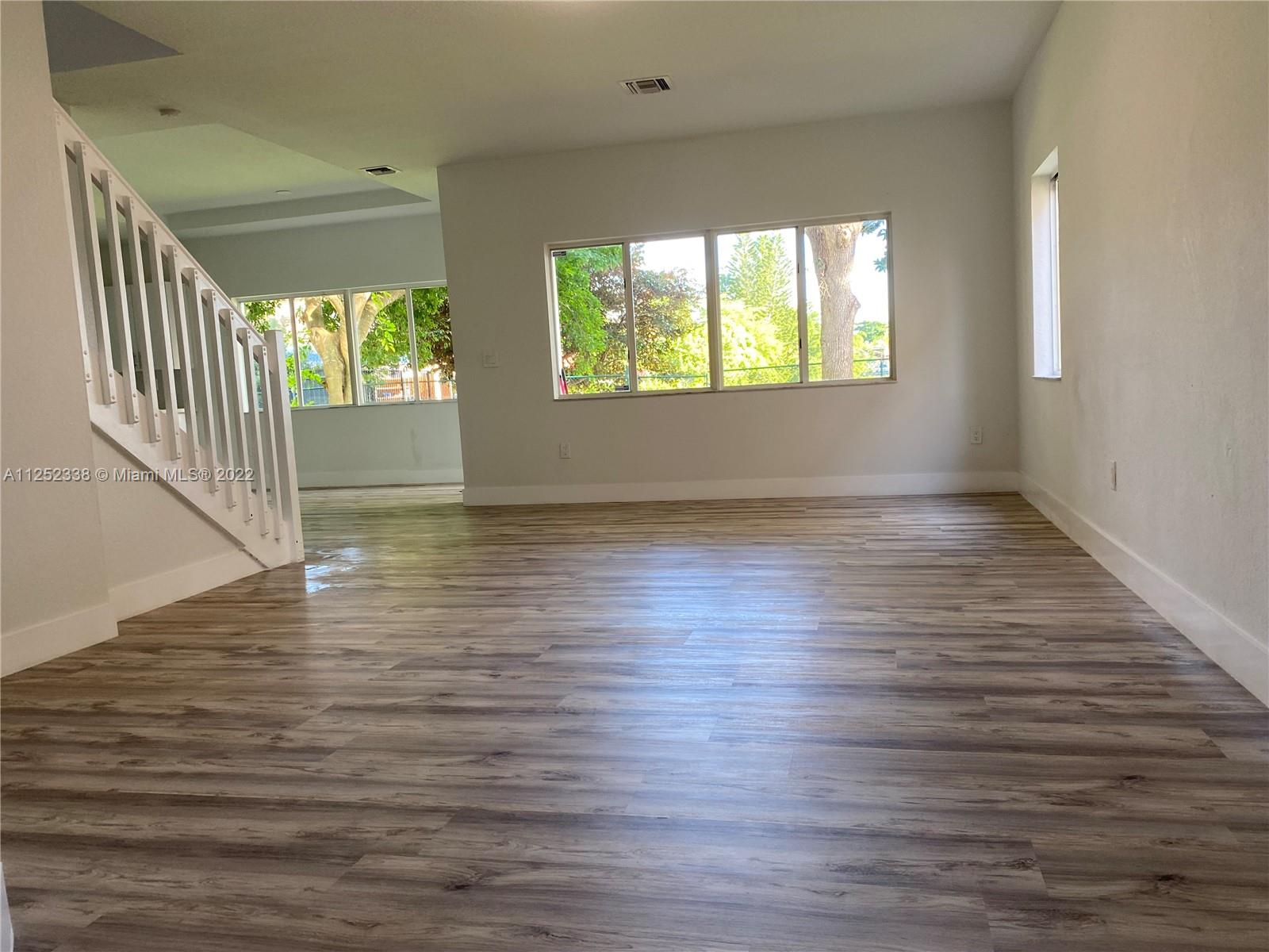 16350 Southwest 50th Terrace Miami, FL 33185 - Photo 7 of 59 an empty room with wooden floor windows and entrance