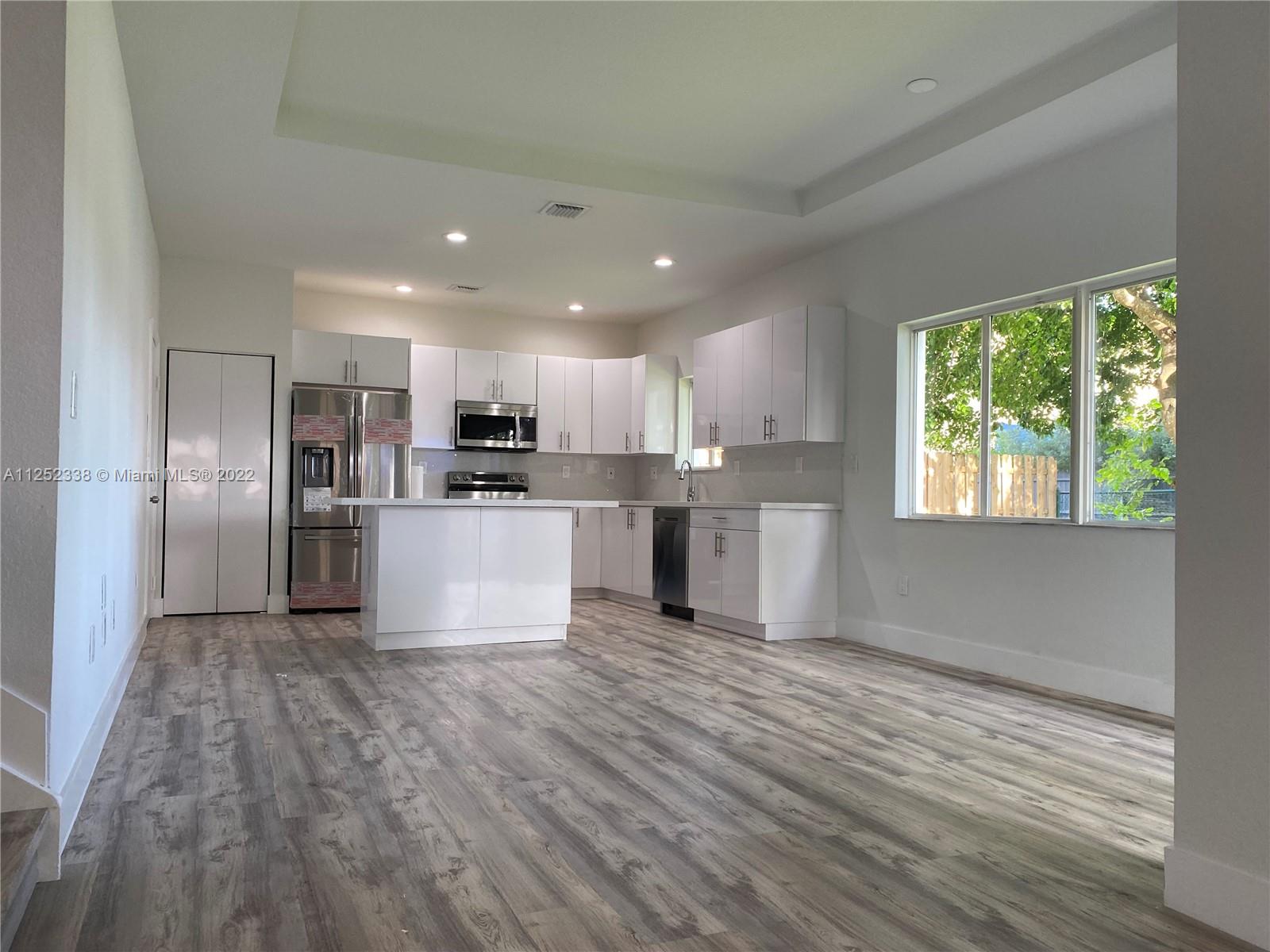 16350 Southwest 50th Terrace Miami, FL 33185 - Photo 9 of 59 a view of kitchen with wooden floor electronic appliances and window