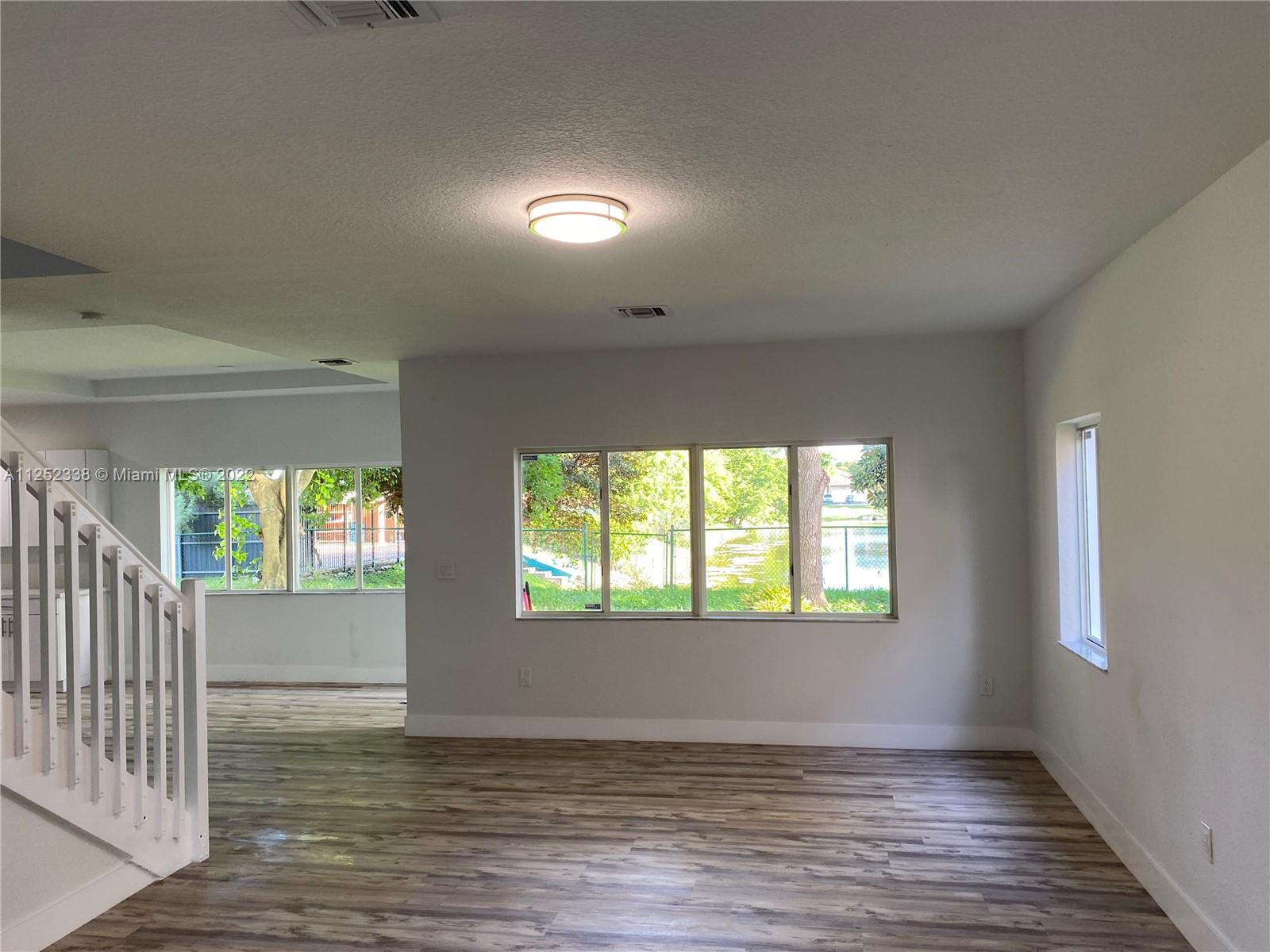 16350 Southwest 50th Terrace Miami, FL 33185 - Photo 10 of 59 an empty room with wooden floor and windows