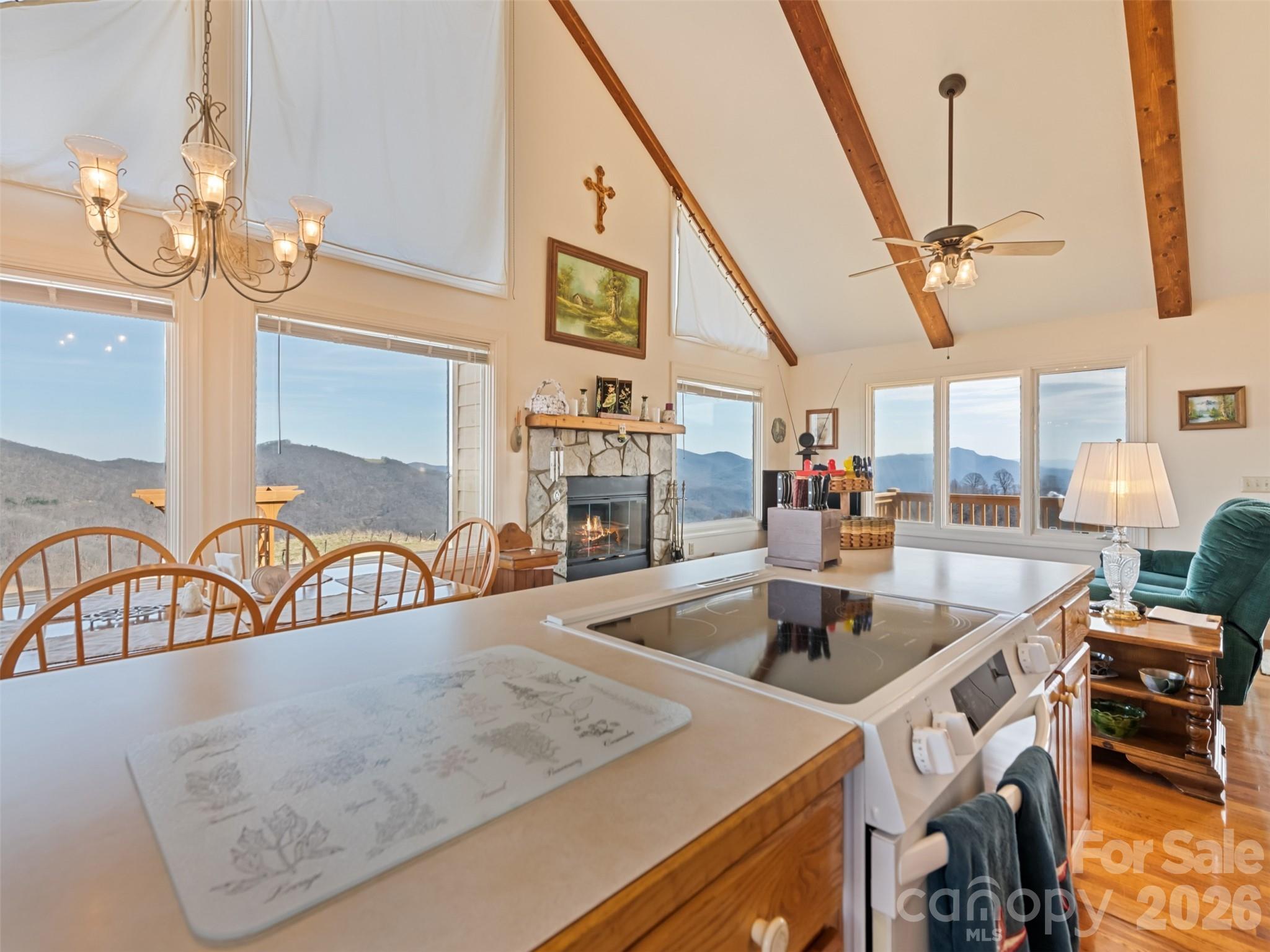 1007 Turkey Trot Road Clyde, NC 28721 - Photo 13 of 48 a kitchen with a sink a counter and chairs